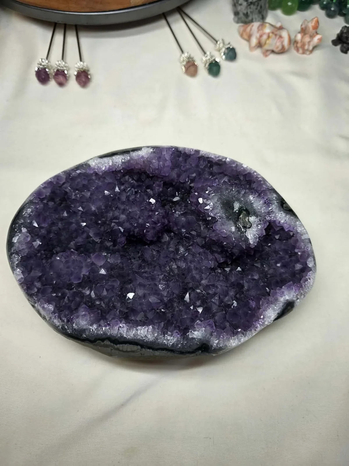 Ann’s oval amethyst geode with a deep purple, densely faceted crystal center.