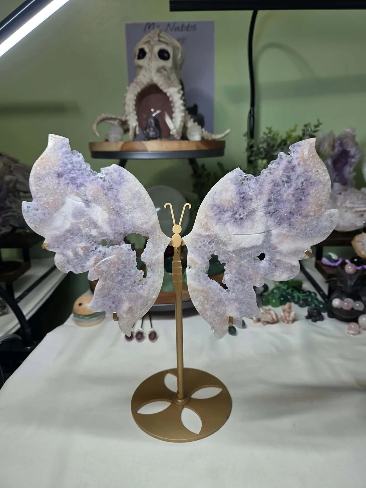 Ann’s amethyst butterfly carving in pale lavender tones on its original gold-colored stand.